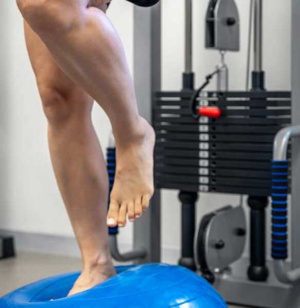 Balance exercise with bosu ball, woman and in a gym, concept of physical therapy for people with injury.
